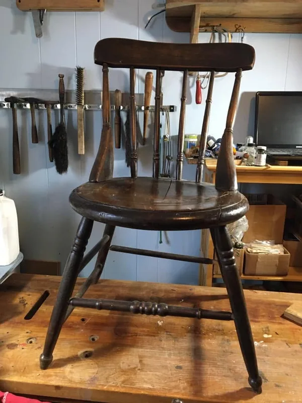 Dark wooden spindle-back chair on the workbench